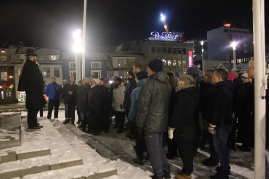 A group of people gathered around their guide