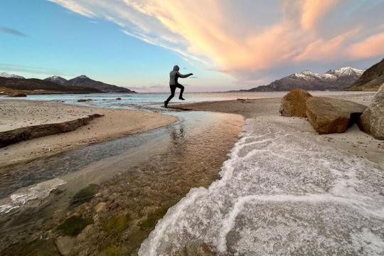 Person enjoying himself at a beach in the Tromso region