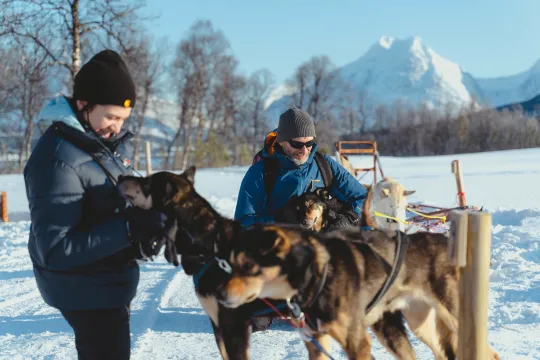 Guests cuddle with the huskies at Camp Tamok