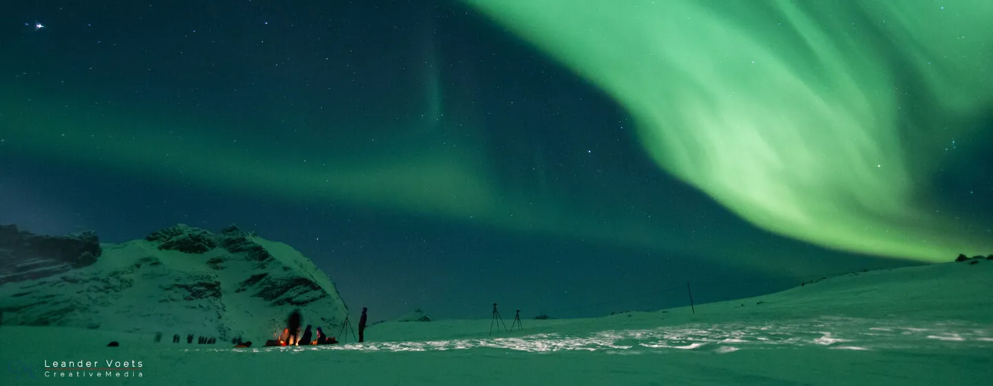 Enjoying the northern lights around a bonfire outside of Tromsø