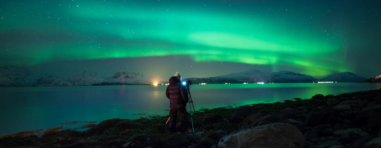 Person photgraphing the northern lights in the Tromsø region