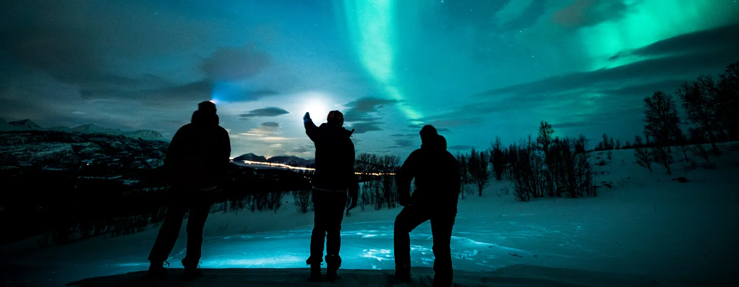 Watching the northern lights in Arctic winter landscape