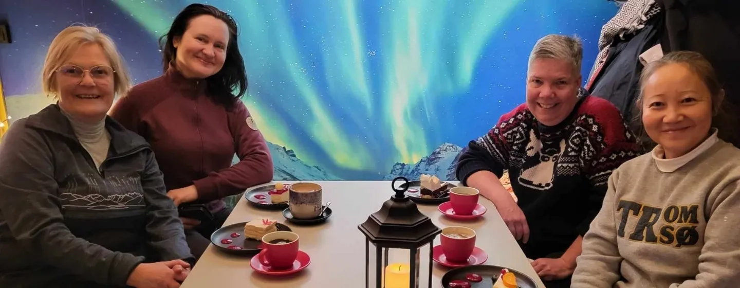 Four guests sitting around a table at a cafe