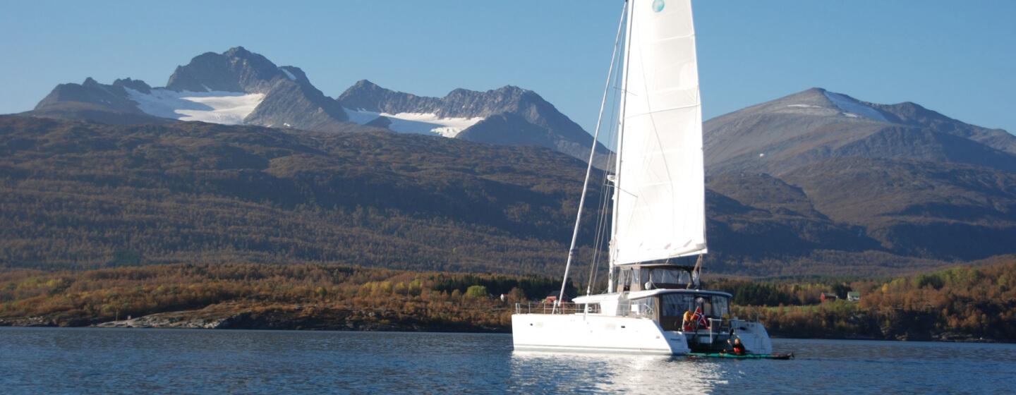 The catamaran Arctic Princess sailing in a fjord
