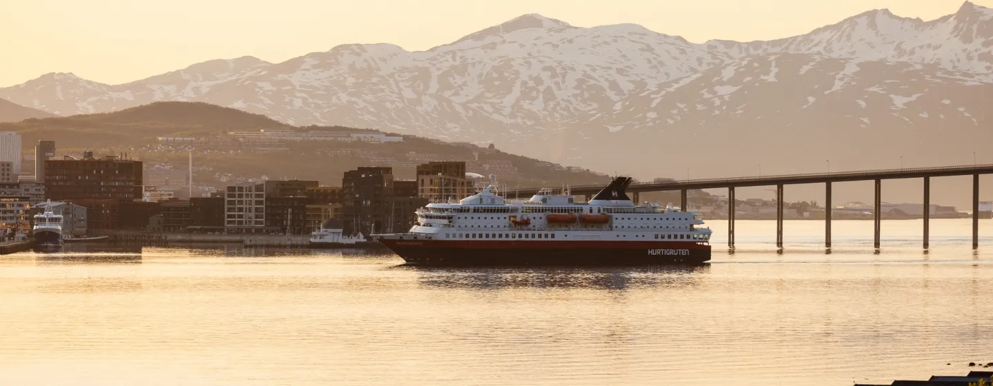 Coastal steamer sailing in the Tromsø sound during the midnight sun season.