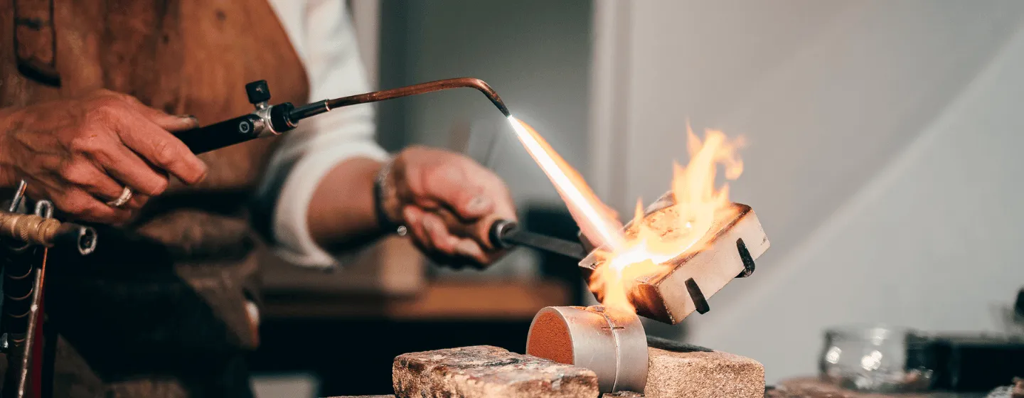 Person melting and making jewelry