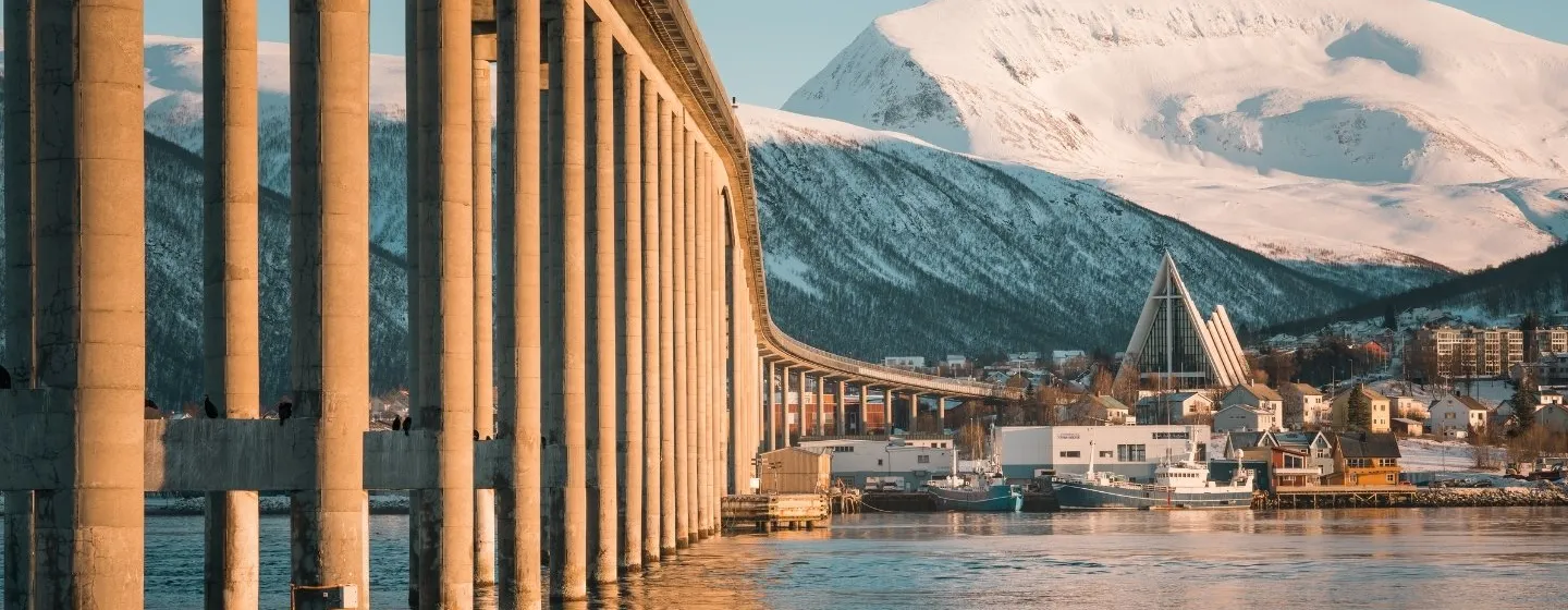 View to the Tromsø bridge, The Arctic Cathedral and the mountain peak Tromsdalstinden during winter in Tromsø. 