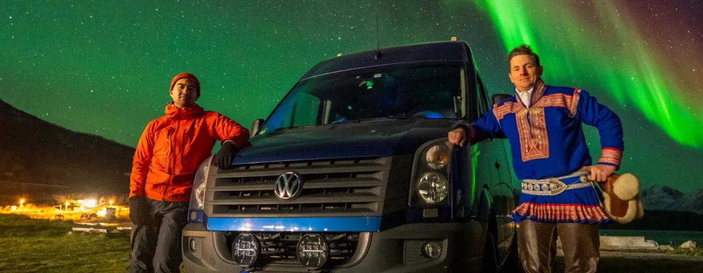 Guests pose in front of the minibus and Aurora