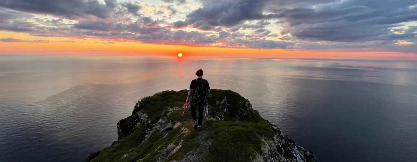 man on top of a mountain watching the sunset Legendary Adventure 