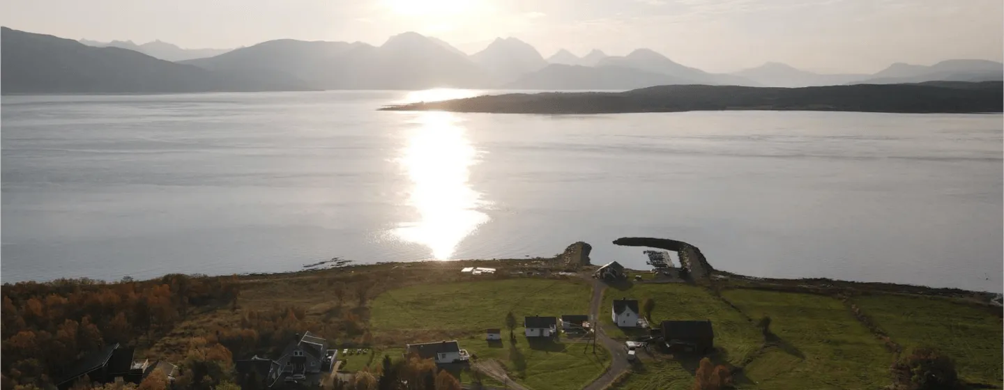 View of Larseng Kystferie during summer with the sea and mountains behind