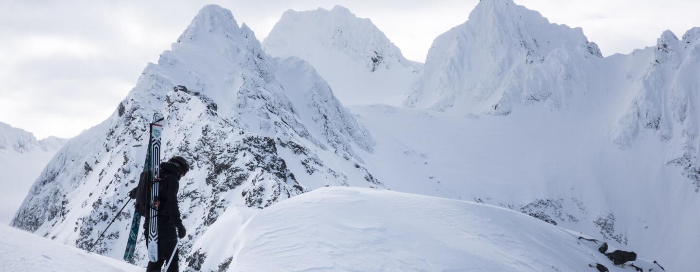 professional skier and filmmaker Nikolai Schirmer skiing down steep mountainsides