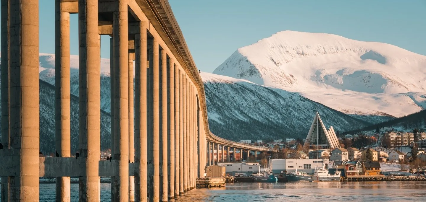View to the Tromsø bridge, The Arctic Cathedral and the mountain peak Tromsdalstinden during winter in Tromsø. 